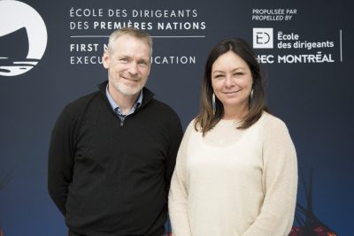 Eric Deschênes and Marie-Claude Cleary stand in front of FNEE's backdrop.